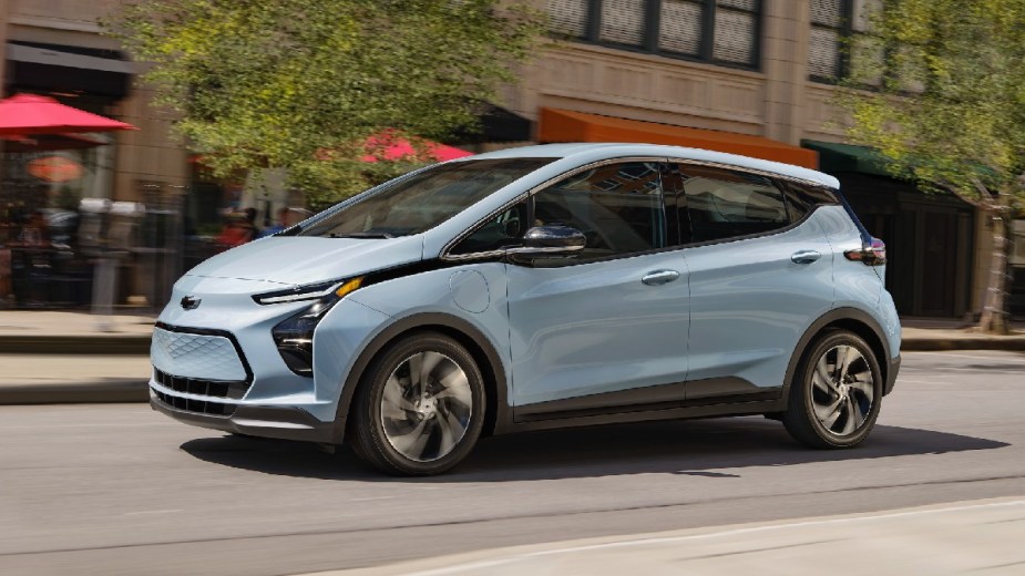 Side view of blue 2023 Chevy Bolt EV, the cheapest new electric car