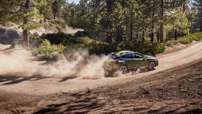 A 2024 Subaru Crosstrek drives on a dusty trail as a small SUV.