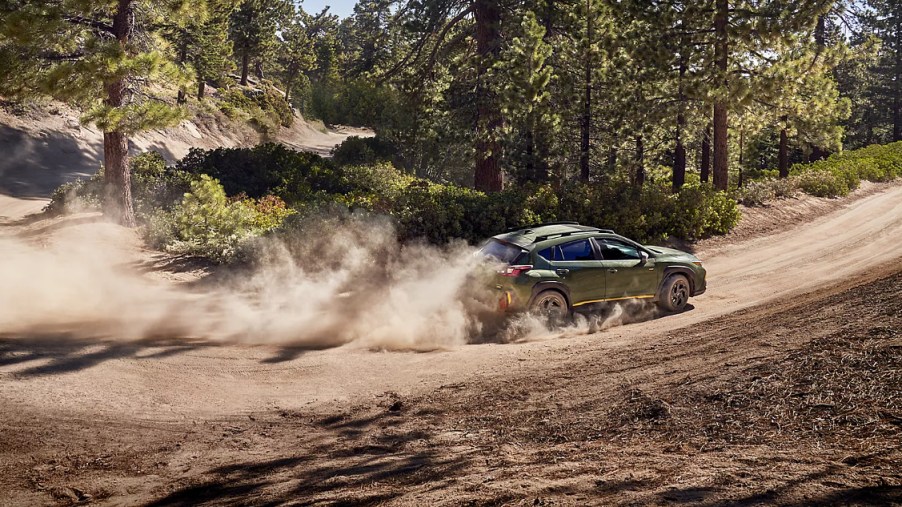 A 2024 Subaru Crosstrek drives on a dusty trail as a small SUV.