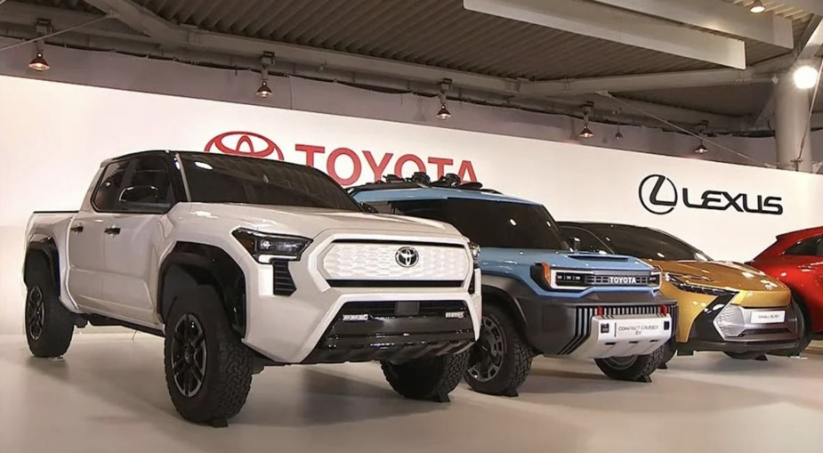 the Toyota Tacoma EV concept on stage near other options