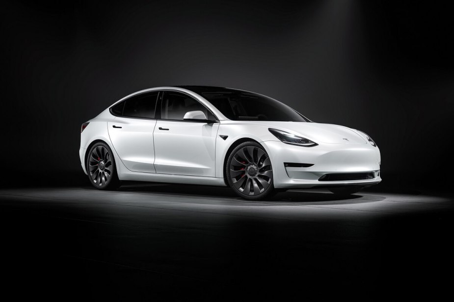 A white Tesla Model 3 shows off its simple aesthetic that made it one of the most popular EVs in the world. 
