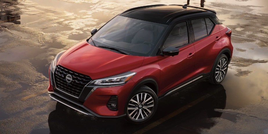A red 2023 Nissan Kicks subcompact SUV is parked. 