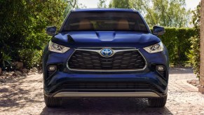 A blue 2023 Toyota Highlander Hybrid midsize SUV is parked.
