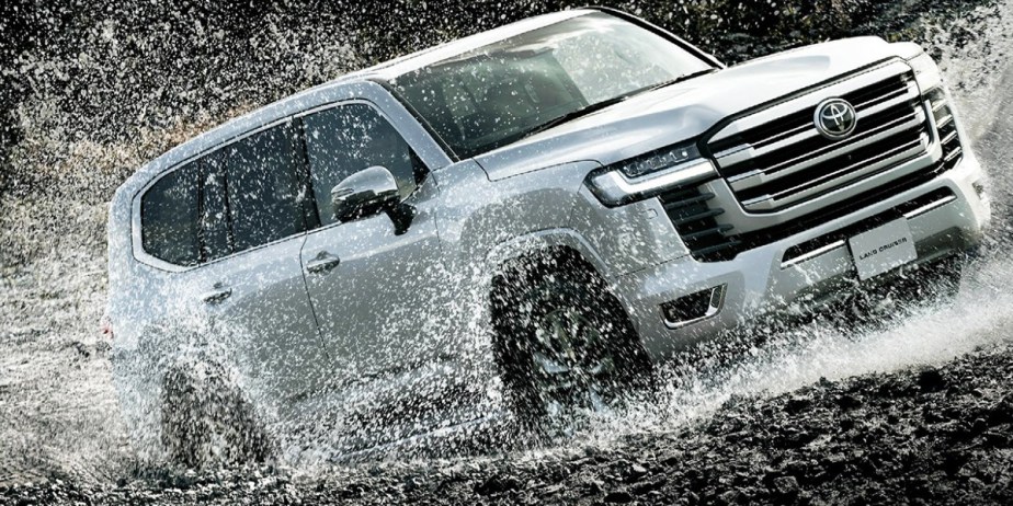 A gray Toyota Land Cruiser full-size SUV  is driving off-road. 