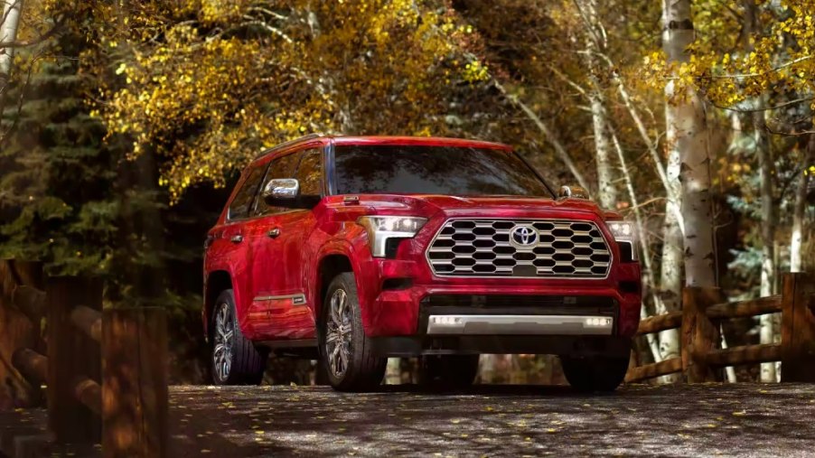 A red 2023 Toyota Sequoia full-size SUV is parked.