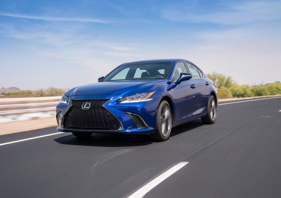 A used Lexus ES 350, a close sibling of the Toyota Camry, shows off its blue paintwork as it cruises back roads. 