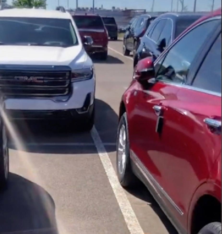 Close-up view of cars parked in GM lot in TikTok video, showing parking trick that stops car accidents