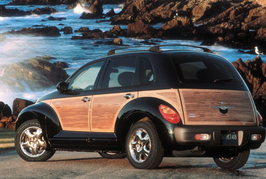 A wood-paneled PT Cruiser parked in front of an ocean backdrop for a publicity photo.