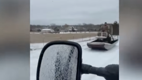 Texas man driving his airboat on the road during an ice storm
