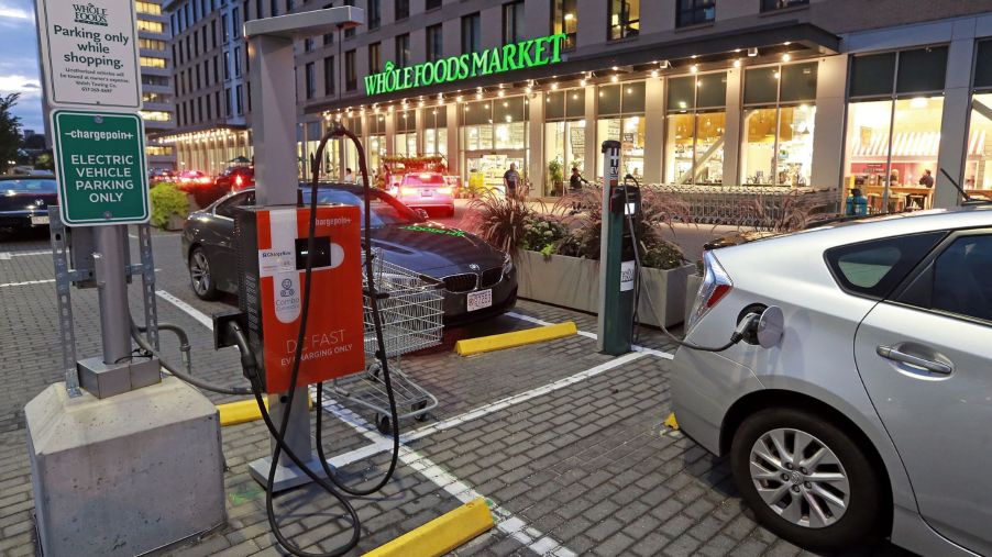 An electric car charging station outside of a Whole Foods in Boston, Massachusetts