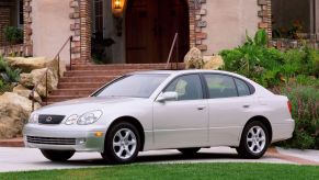 A gray 2001 Lexus GS 300 executive car/luxury sedan model parked outside a luxury home/villa