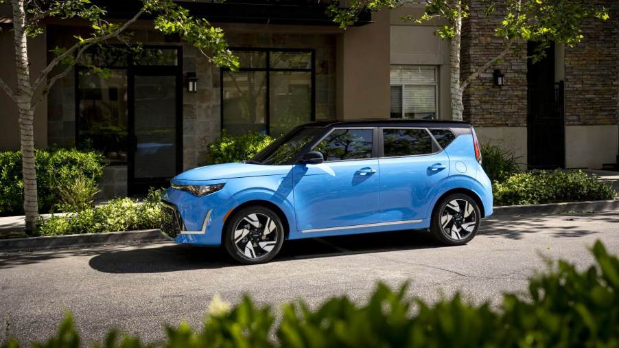 A light blue 2023 Kia Soul subcompact SUV/CUV model parked under tree shade