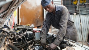 A mechanic working on an old engine.
