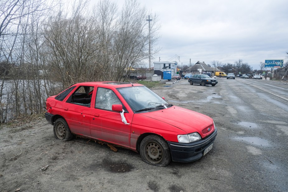 An old red Toyota Tercel sitting abandoned. 