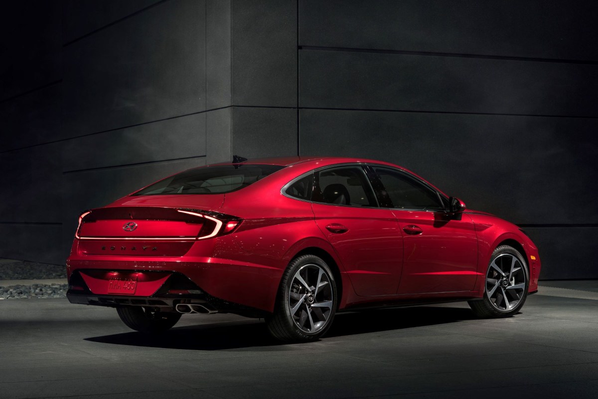 A rear exterior promotional photo of a red 2023 Hyundai Sonata midsize sedan model