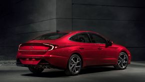 A rear exterior promotional photo of a red 2022 Hyundai Sonata midsize sedan model