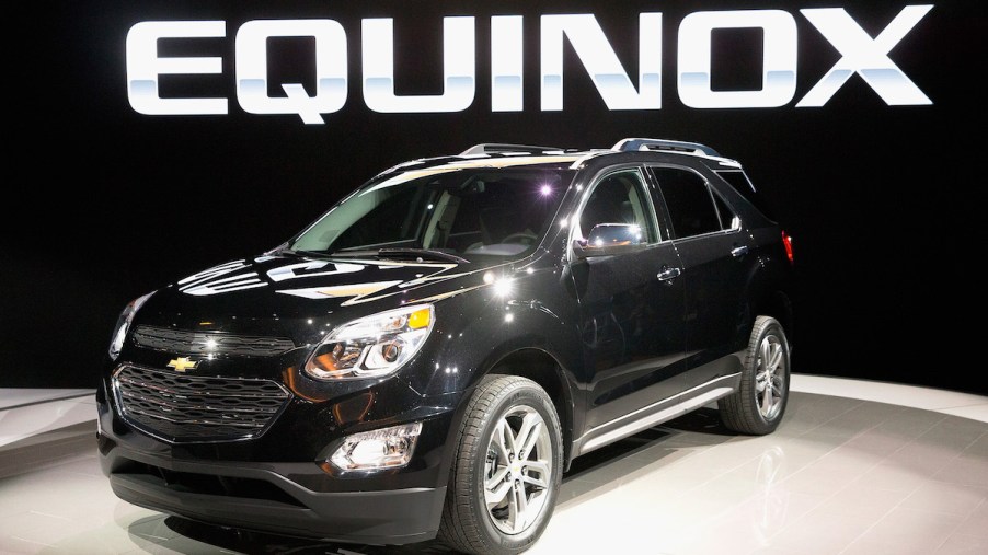 A black used Chevy Equinox parked indoors.