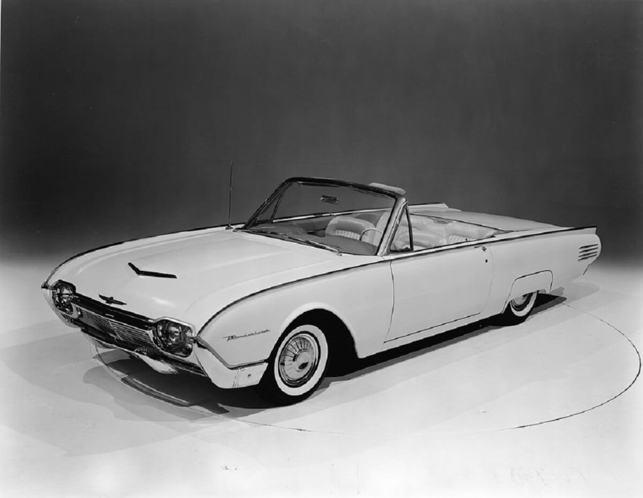 A 1961 Ford Thunderbird sits on a stage with a surplus of trendy 1960s style. 