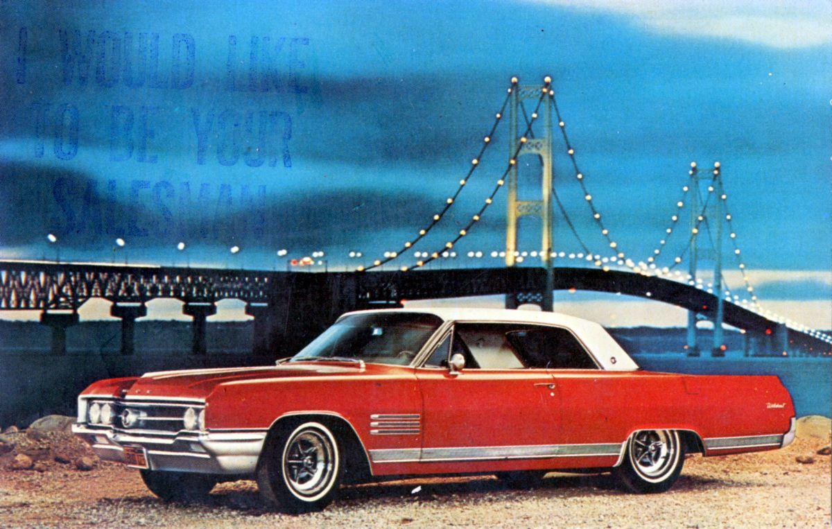 A red 1964 Buick Wildcat on a General Motors (GM) postcard with the Golden Gate Bridge