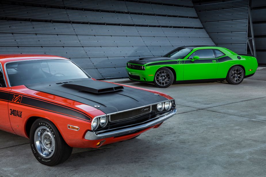 Red 1970 Dodge Challenger parked in front of a lime green 2017 T/A for a promo photo of the newer car.
