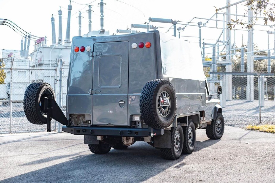 The tailgate and swing out rear tires of a Land Rover Defender 6x6 truck.