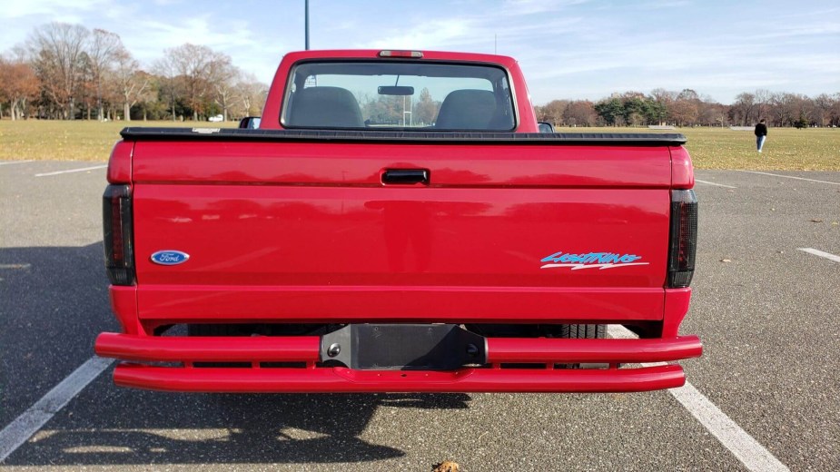 The tailgate of a bright red Ford F-150 SVT Lightning supertruck.