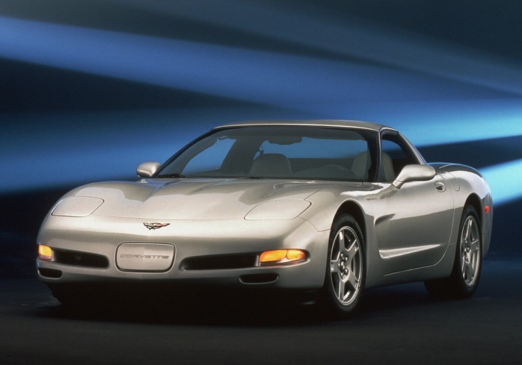 A silver 1997 Chevrolet Corvette C5 poses on a stage. 