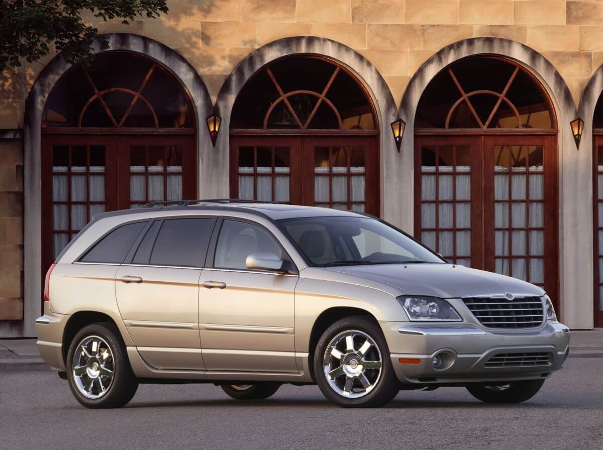 A shiny yellow beige 2005 Chrysler Pacifica Limited minivan model parked in front arched glass doors