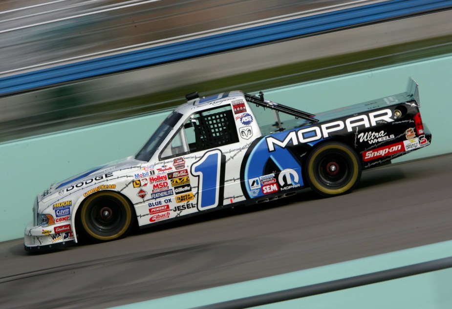MOPAR branded Dodge truck racing around a NASCAR track.