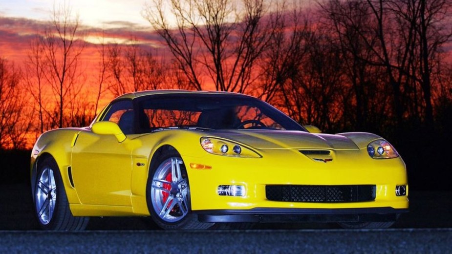 Yellow 2006 Chevrolet Corvette Z06 at dusk with a sunset background