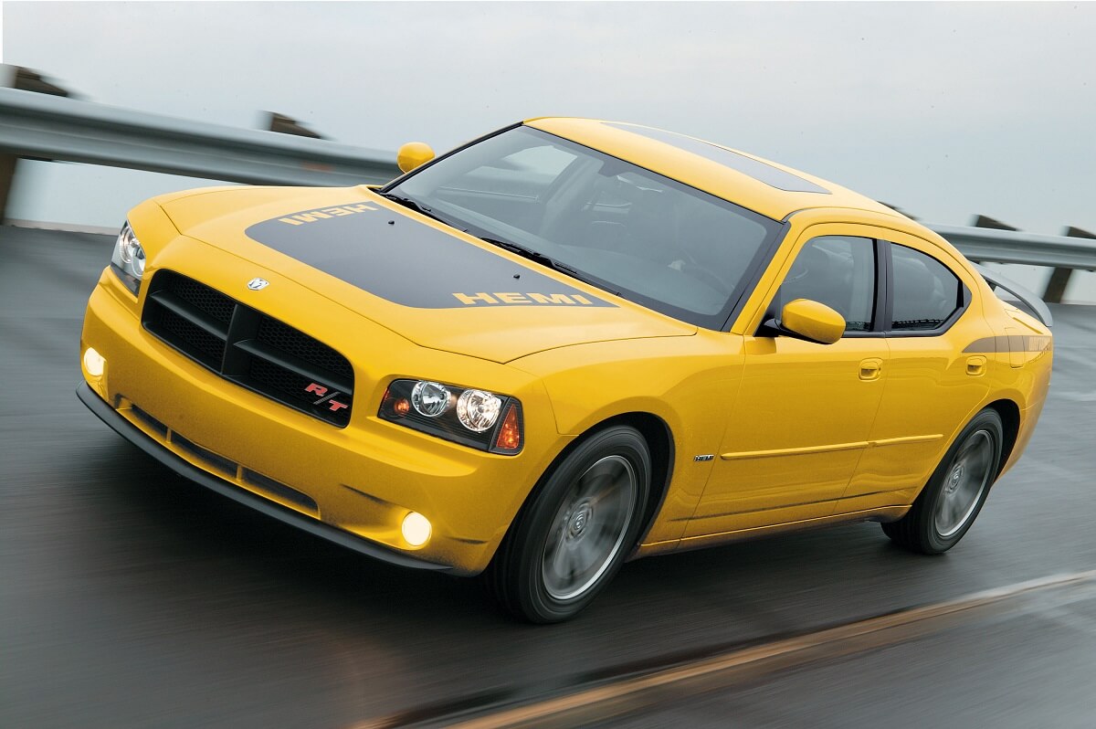 A yellow and black used 2006 Dodge Charger Daytona blasts across a banked section of track.