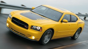A yellow and black used 2006 Dodge Charger Daytona blasts across a banked section of track.