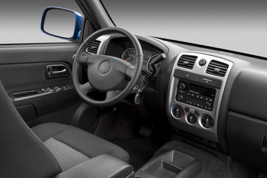 The gray cloth and plastic interior of a first-generation Chevrolet Colorado.