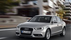 A silver 2011 Audi A4 cruises down city streets.