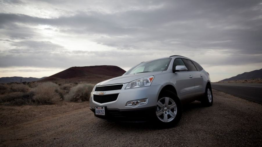 A silver 2011 Chevy Traverse full-size SUV model at State Highway 395 in the Mojave Desert