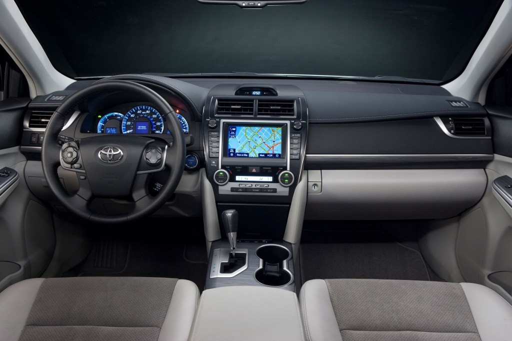 A Toyota Camry's interior shows off its infotainment screen, AC vents, and space for a smell-mitigating freshener.
