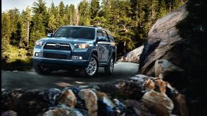 2013 Toyota 4Runner with rocks in foreground and trees in background.