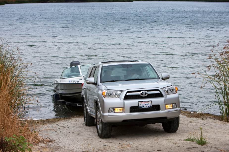 A 2013 4Runner pulls a boat out of a lake. 
