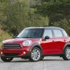 A red 2013 Mini Cooper Countryman subcompact luxury crossover SUV model parked on an asphalt road