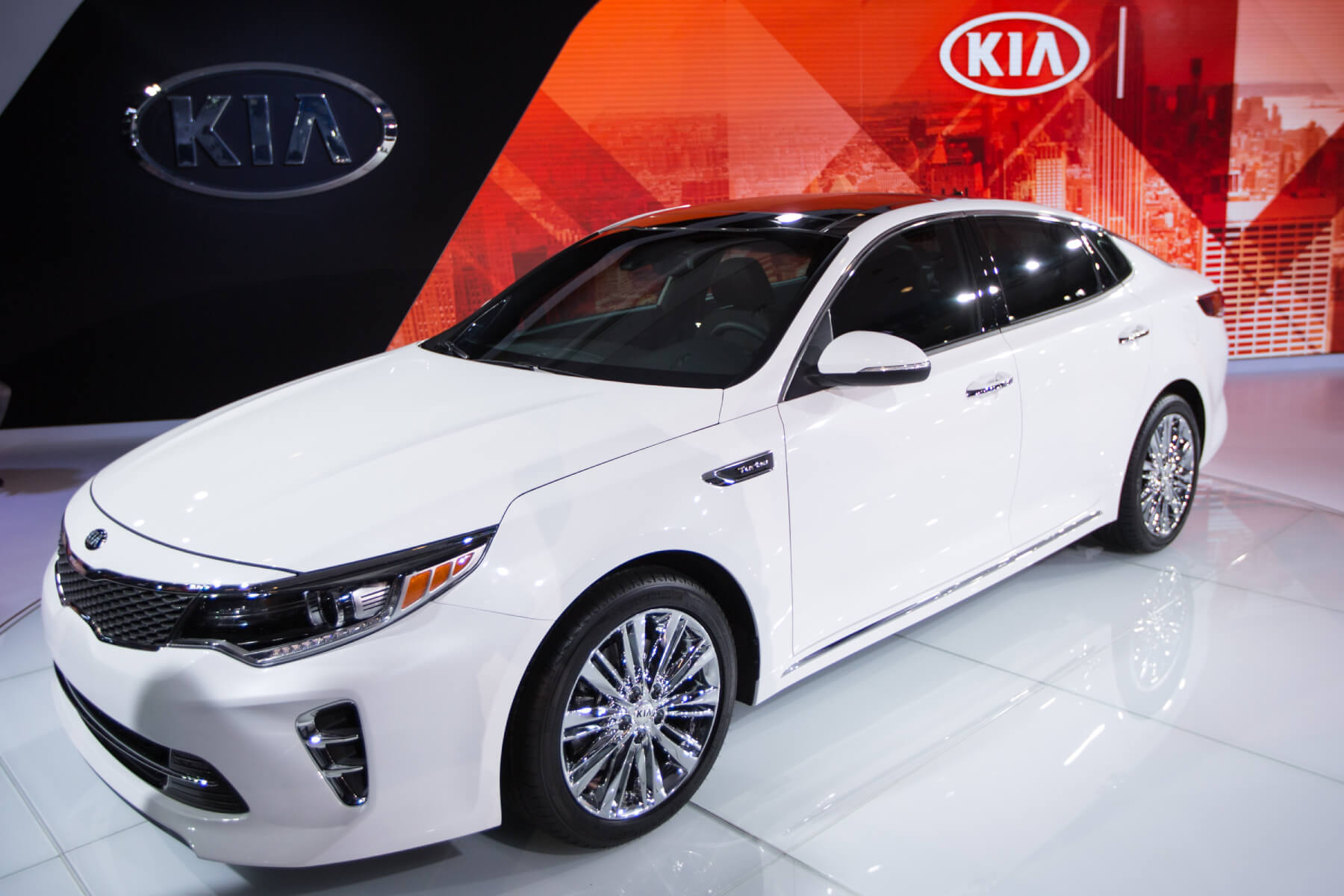 A white Kia Optima sits on the floor of an auto show. The Optima is among various models at risk for theft after a viral TikTok trend.