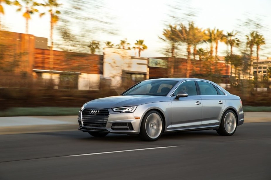 A used silver 2017 Audi A4 shows off its problem-free sports sedan styling on a coastal road. 