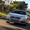A silver 2017 Audi A4 luxury car corners on a smooth road.
