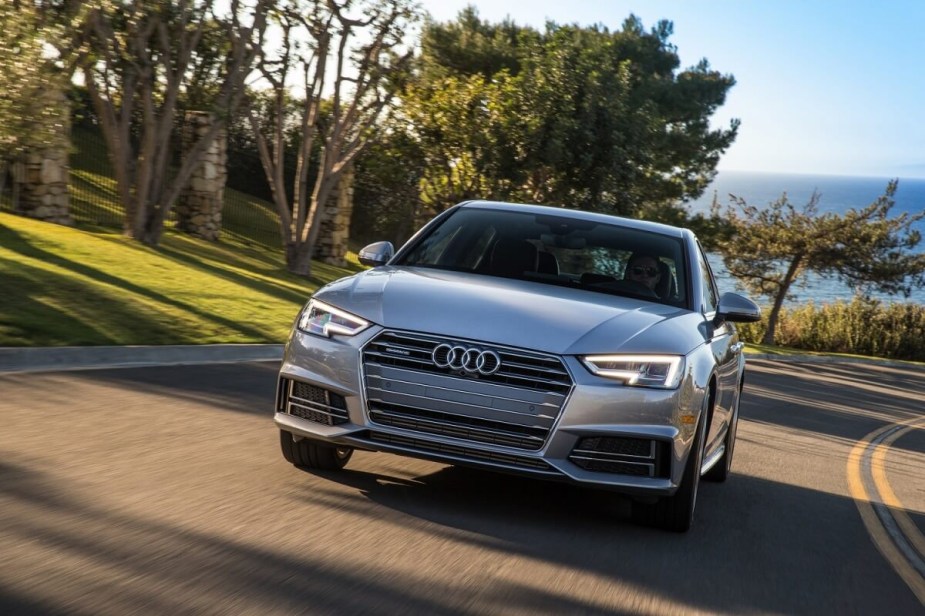 A silver 2017 Audi A4 luxury car corners on a smooth road. 