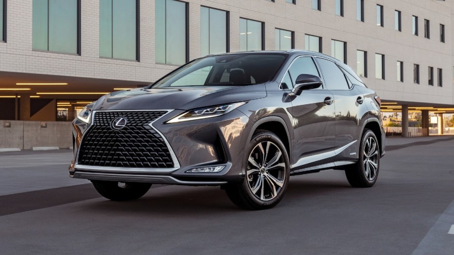 Gray 2020 Lexus RX 450h driving next to a building