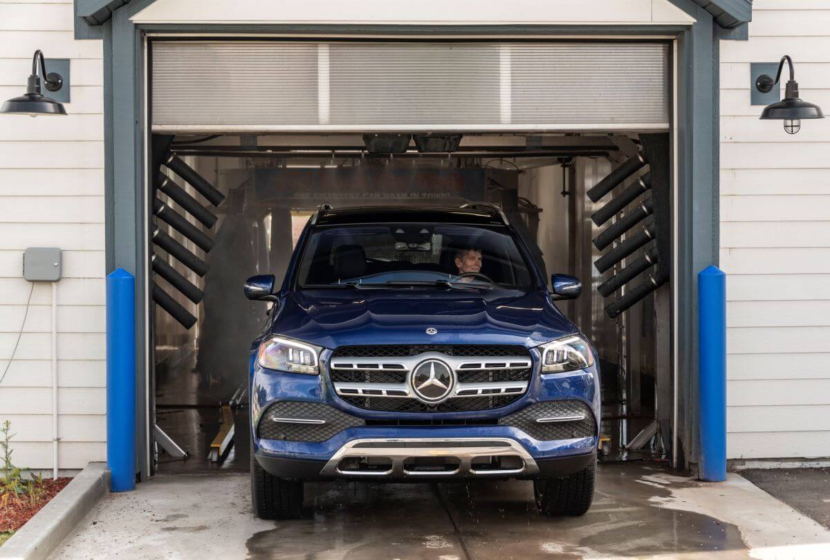 A blue 2020 Mercedes-Benz GLS 450 4MATIC full-size luxury SUV model exiting a car wash