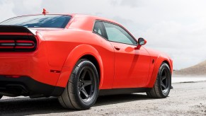 An orange Dodge Challenger SRT Hellcat Redeye parks on salt flats.