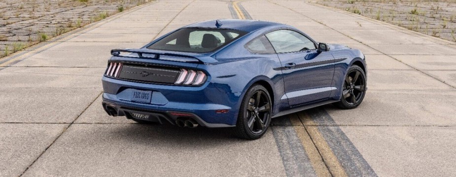 An S550 2023 Ford Mustang EcoBoost shows off its blue paintwork on a runway. 