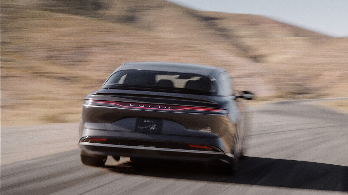A 2022 Lucid Air Grand Touring driving down a highway.