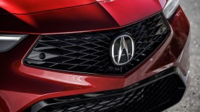 A red 2023 Acura Integra grille, which is the Acura sedan that is the best.