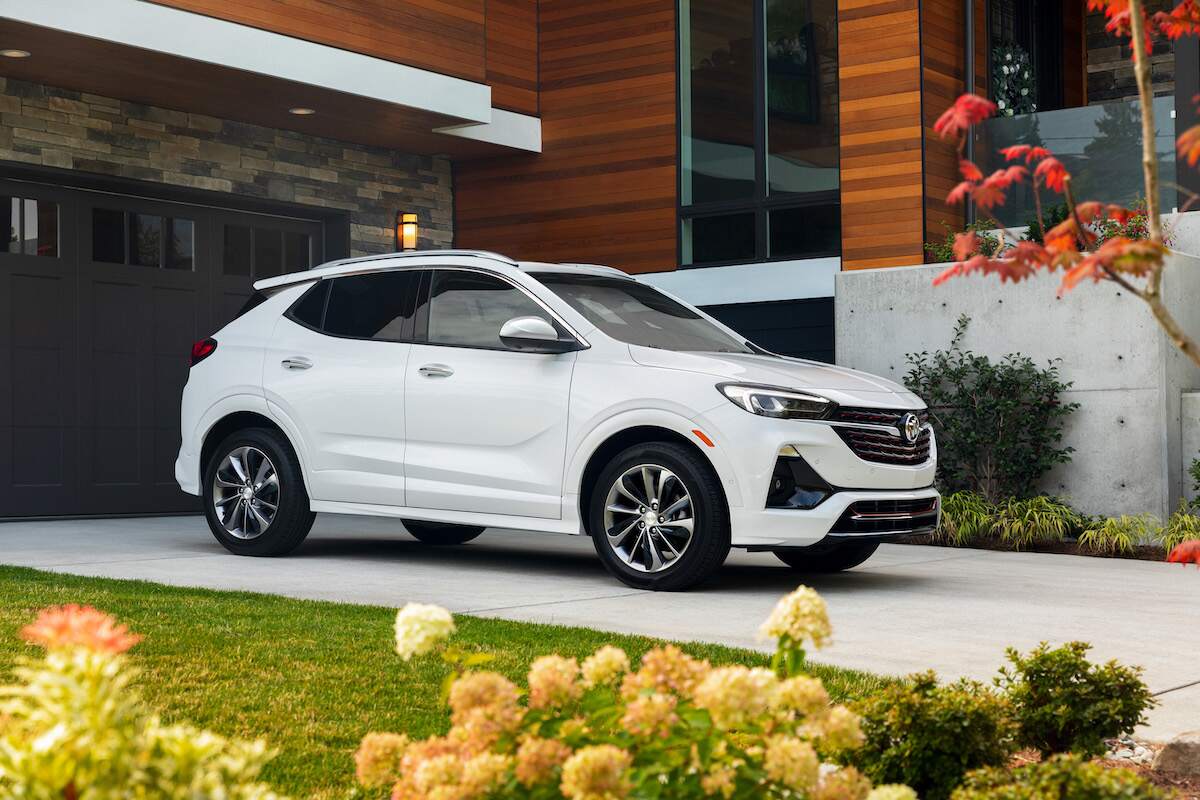 A white 2023 Buick Encore GX, which is one of the top-rated Buick SUVs, parked in front of a building.